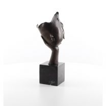 A BRONZE SCULPTURE OF A FACE RESTING ON HAND PALM