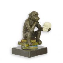 A BRONZE SCULPTURE OF A DARWIN MONKEY ON BOOKS ANTIQUE COLOR
