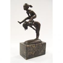 A BRONZE SCULPTURE OF TWO CHILDREN PLAYING LEAP-FROG