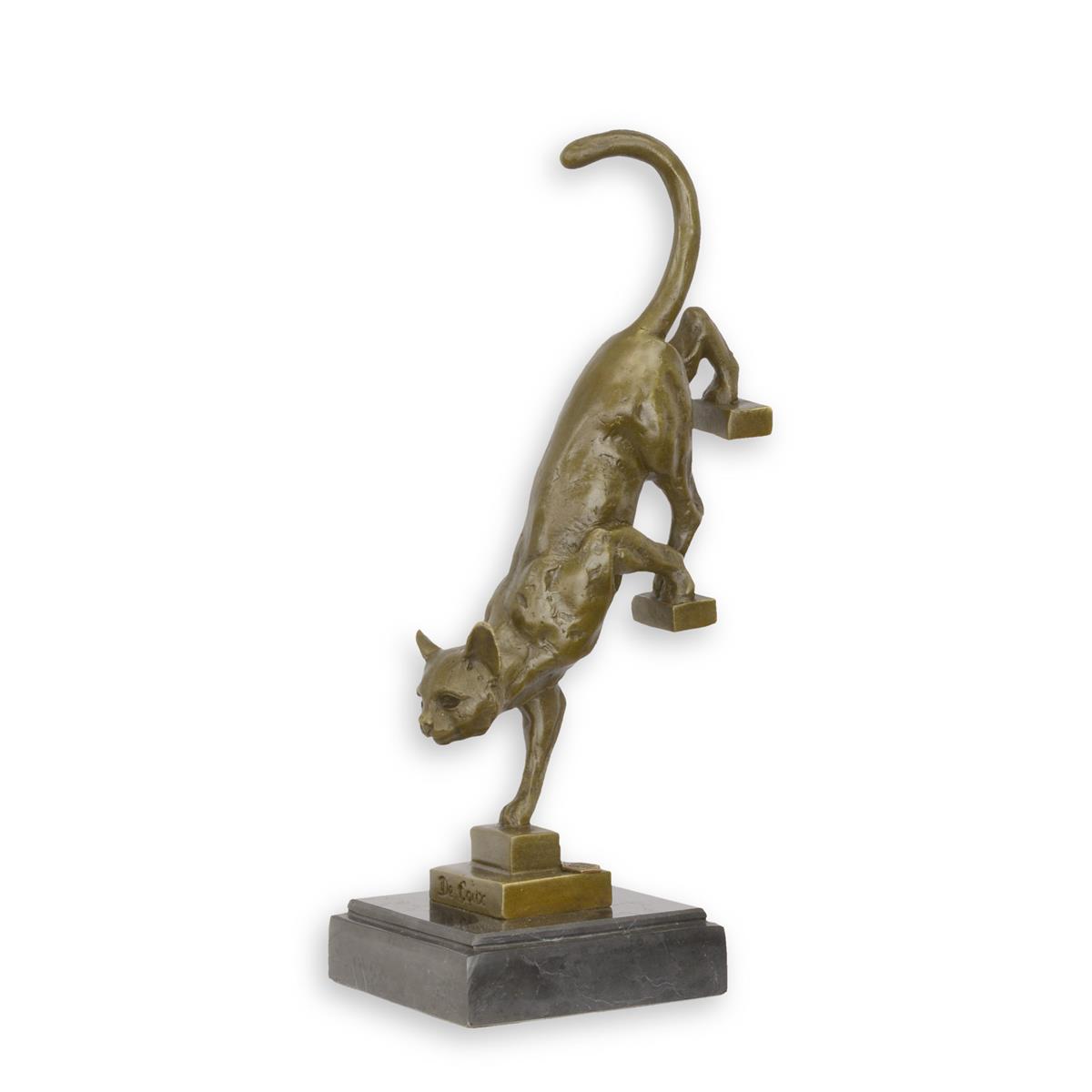 A BRONZE SCULPTURE OF A CAT DESCENDING THE STAIRS