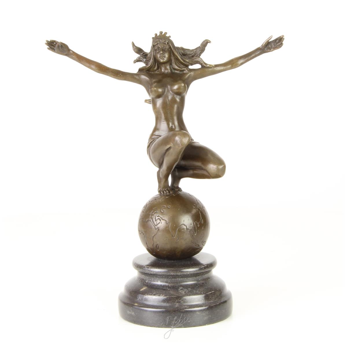 A BRONZE SCULPTURE OF A WOMAN ON TOP OF THE WORLD
