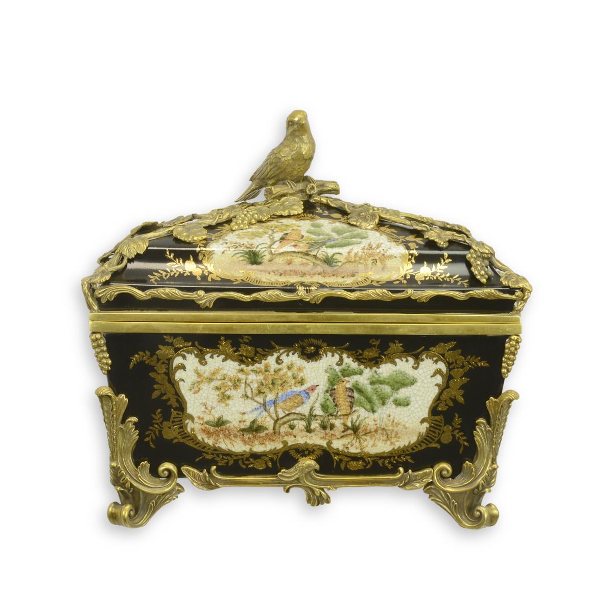 A BLACK-GROUND BRASS MOUNTED PORCELAIN BOX AND COVER