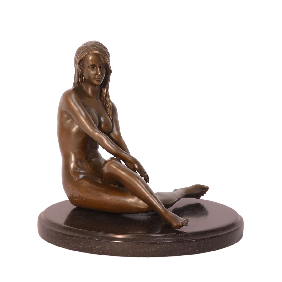 A BRONZE SCULPTURE OF A SITTING NUDE